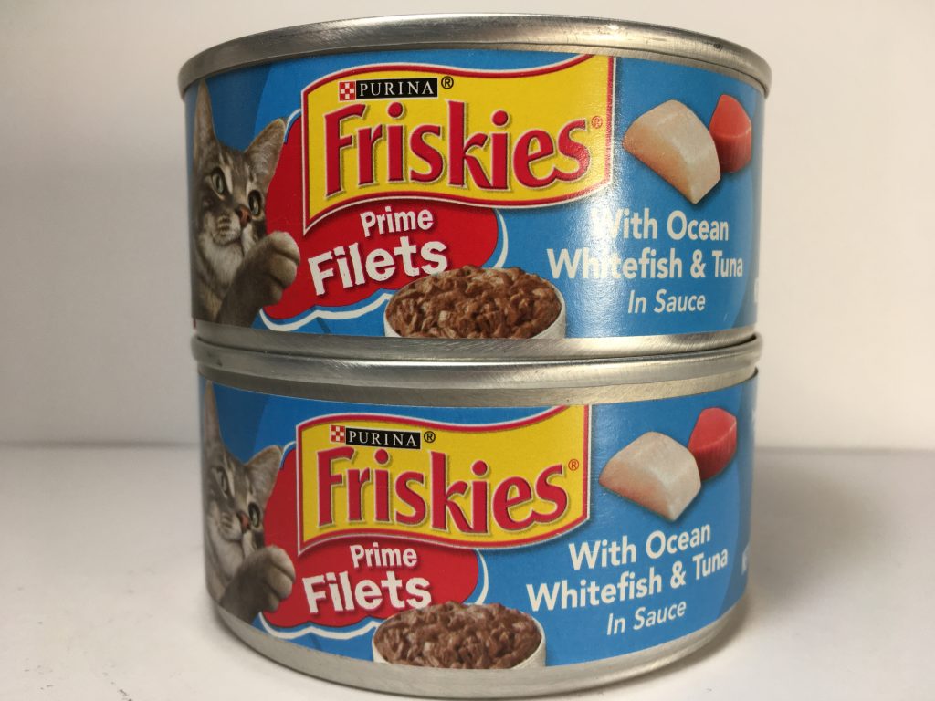 The front of two cans of delicious cat food stacked together, friskies prime filets with Ocean Whitefish and Tuna in Sauce