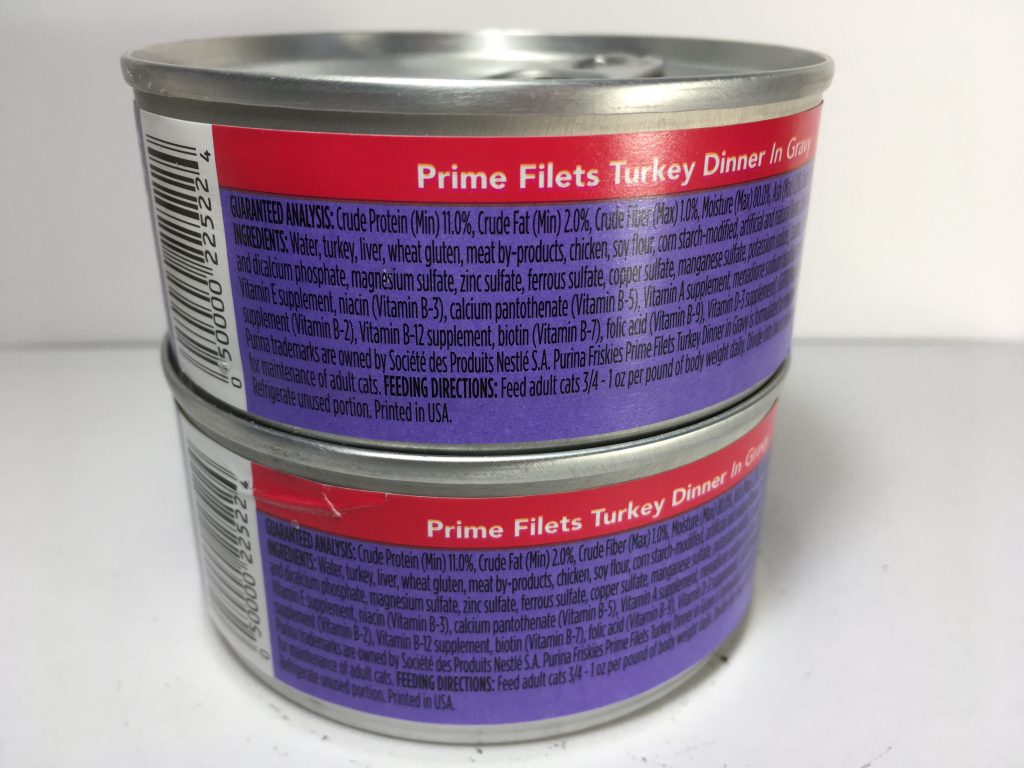 The back of two cans of delicious cat food stacked together, friskies, Prime Filets, Turkey Dinner in Gravy