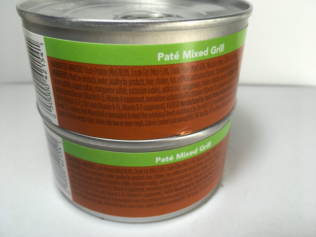 The back of two cans of delicious cat food stacked together, friskies pate, mixed grill