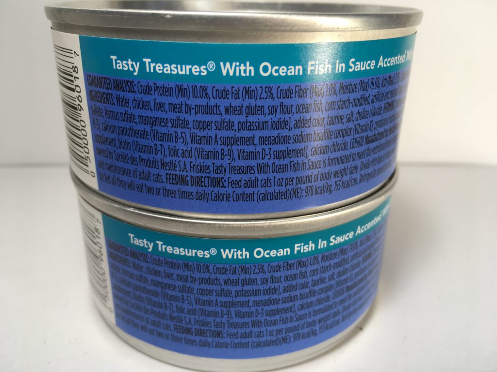 The back of two cans of delicious cat food stacked together, friskies tasty treasures, accented with bacon, with Ocean Fish in Sauce, mixed grill